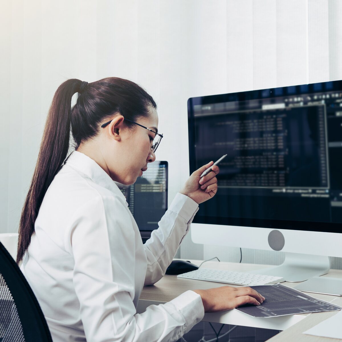 Analyst reviewing technical data across sectors